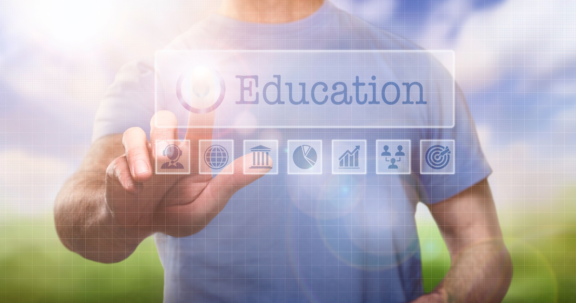 A man in a t-shirt outside selecting a Education word concept